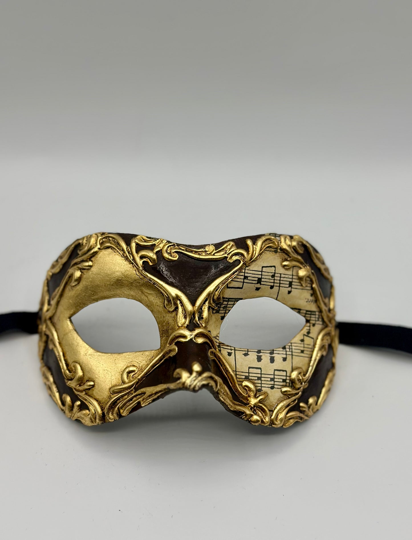 Masque motif notes de musique en or et marron